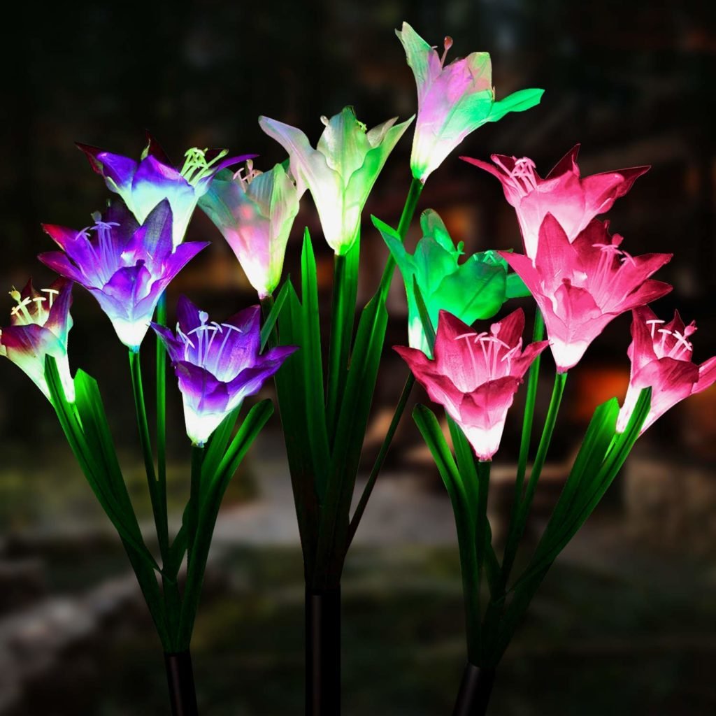 Artificial lilies with glowing colour-changing LED blooms against a dark background