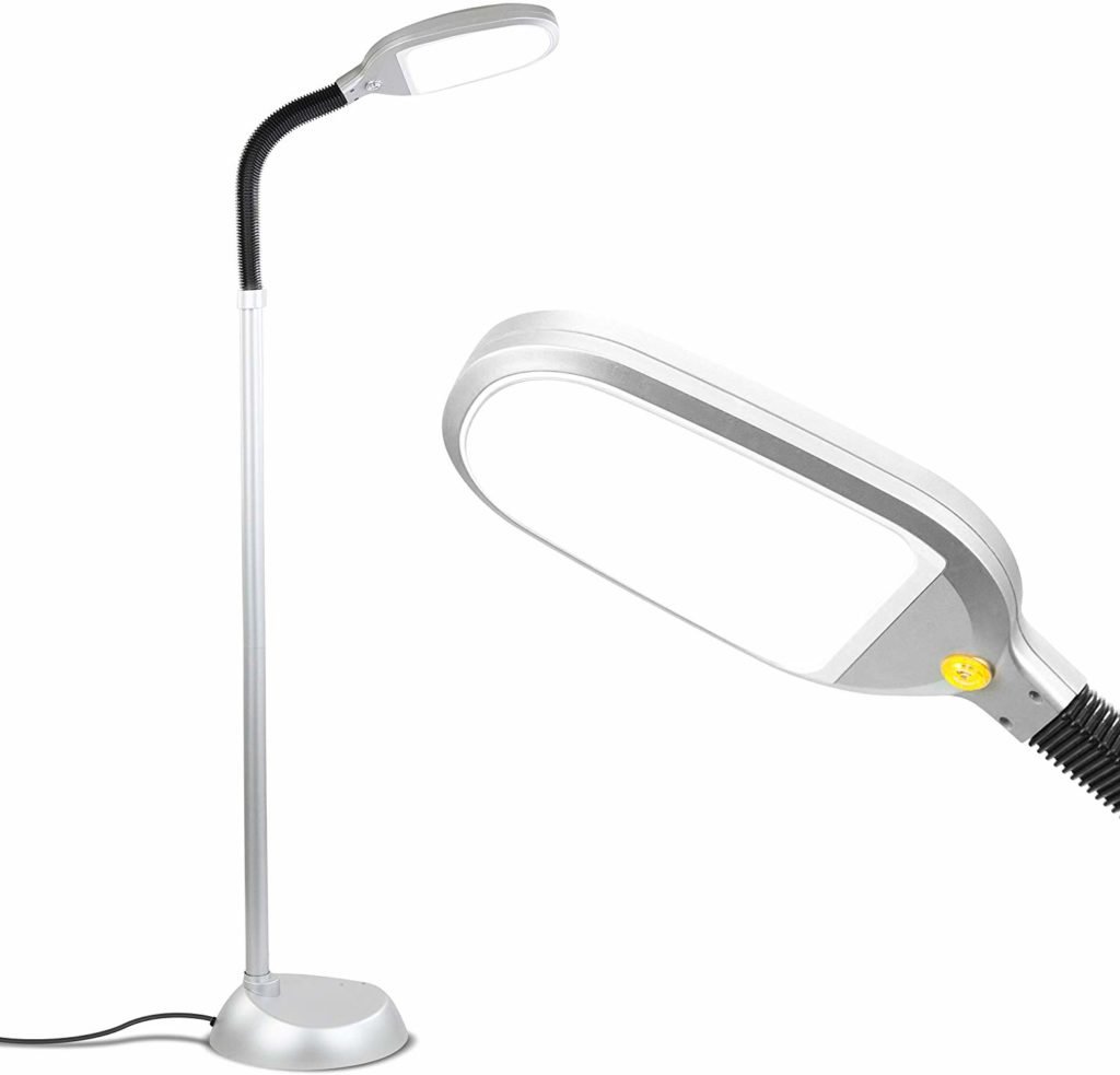 White and silver floor lamp with a close-up of its lamp head
