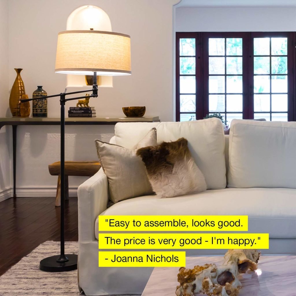 Floor lamp in a living room next to a sofa with pillows