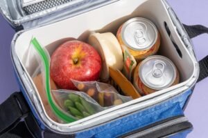 Open cooler bag packed with food, drinks and an ice pack